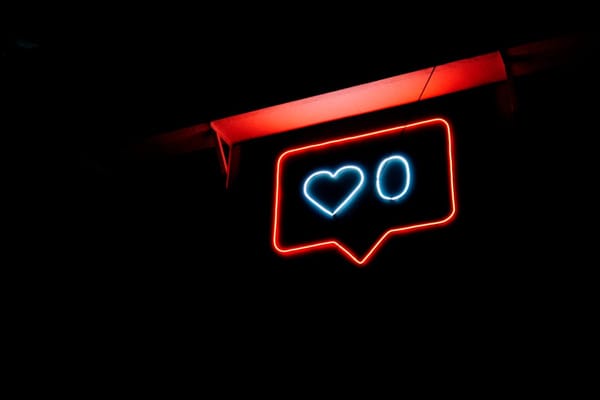 Neon sign depicting a typical social media prompt to “like” something. Photo by Prateek Katyal / Unsplash.